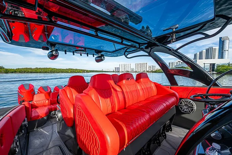 Slide: The Image of Luxurious 2021 Midnight Express 43 Solstice boat with vibrant red seating and modern design. - 17