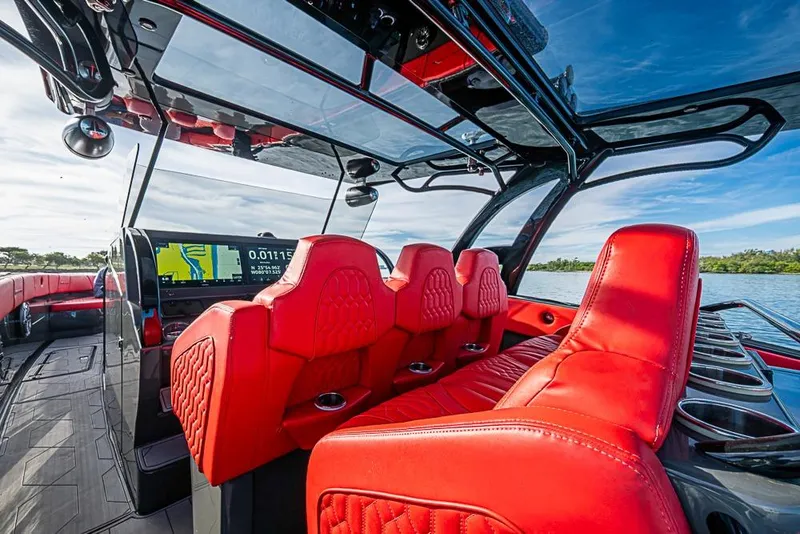 Slide: The Image of Luxurious 2021 Midnight Express 43 Solstice boat interior with vibrant red seating and modern dashboard. - 20
