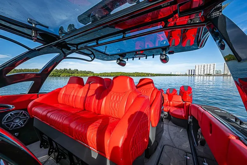 Slide: The Image of Luxurious red interior of 2021 Midnight Express 43 Solstice boat on serene water. - 21
