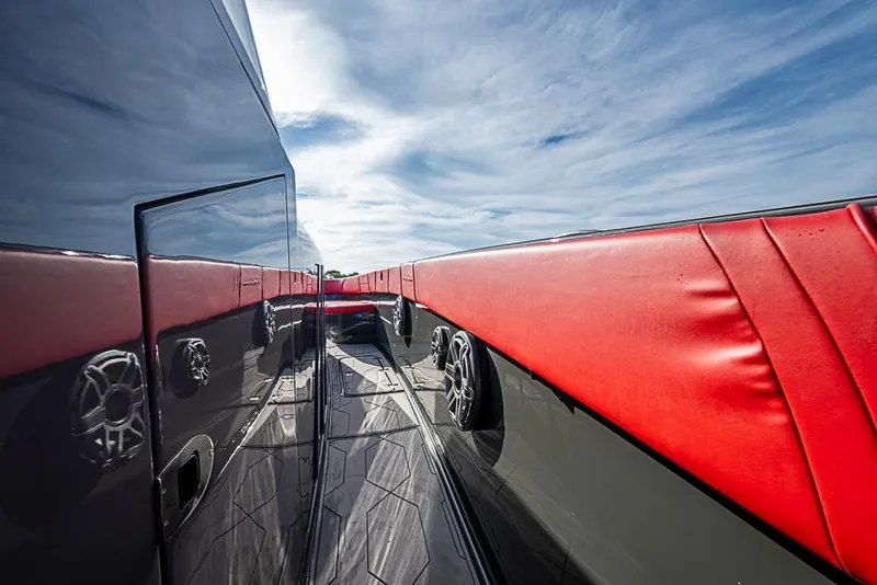 Slide: The Image of 2021 Midnight Express 43 Solstice yacht with sleek design and red accents under blue sky. - 23