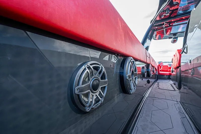 Slide: The Image of 2021 Midnight Express 43 Solstice boat interior with red seating and built-in speakers. - 24