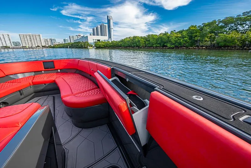Slide: The Image of Luxurious 2021 Midnight Express 43 Solstice boat with red seating, city skyline view. - 25