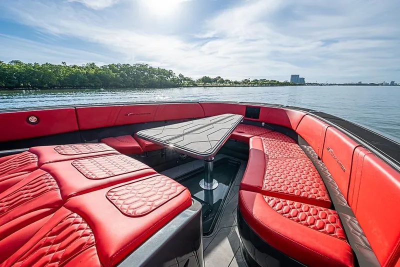 Slide: The Image of Luxurious 2021 Midnight Express 43 Solstice boat with red seating and scenic water view. - 26
