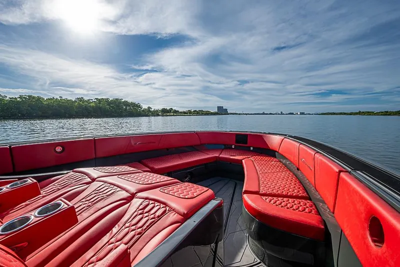 Slide: The Image of Luxurious 2021 Midnight Express 43 Solstice boat with red seating on a serene lake. - 27