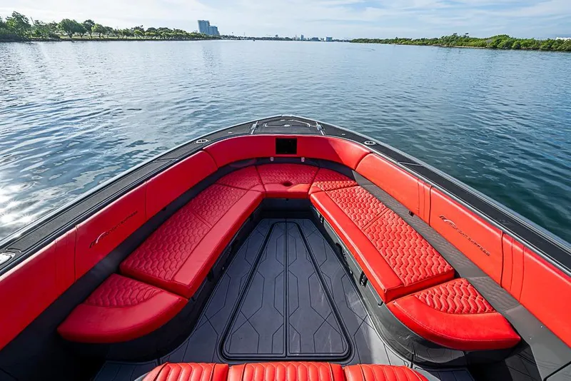 Slide: The Image of Luxurious 2021 Midnight Express 43 Solstice boat with red seating on calm water. - 28