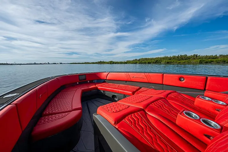 Slide: The Image of Luxurious 2021 Midnight Express 43 Solstice boat with vibrant red seating on calm water. - 32