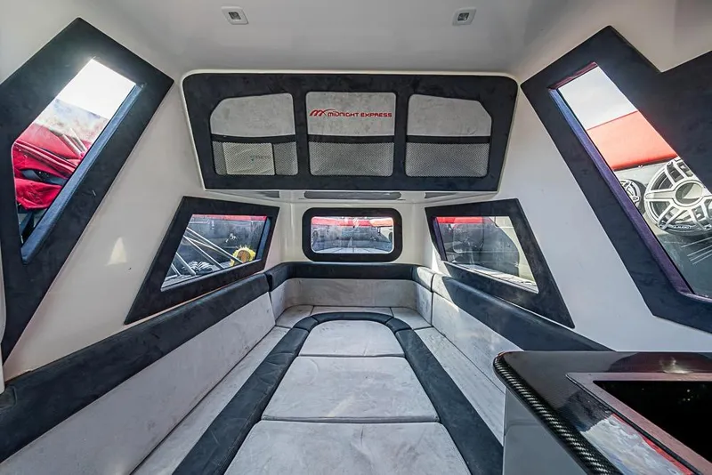 Slide: The Image of Interior of 2021 Midnight Express 43 Solstice boat, featuring modern seating and windows. - 36