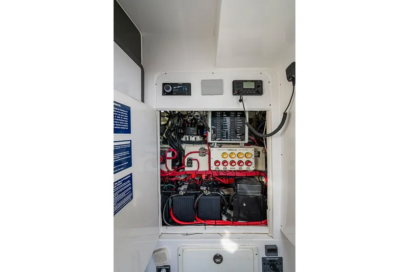 Slide: The Image of Electrical panel of 2021 Midnight Express 43 Solstice boat, showcasing wiring and controls. - 40