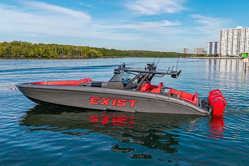 Slide: The Image of 2021 Midnight Express 43 Solstice boat on calm water, featuring sleek design and vibrant red accents. - 46