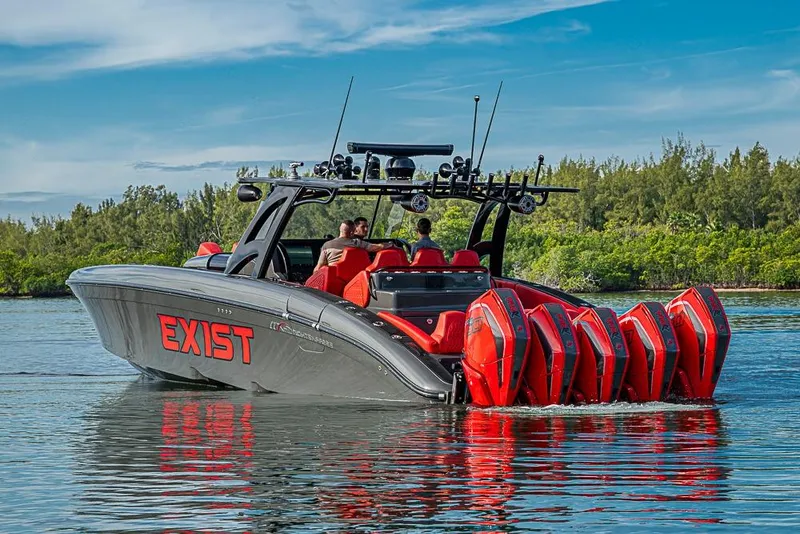 Slide: The Image of 2021 Midnight Express 43 Solstice boat with six red engines on a calm waterway. - 48