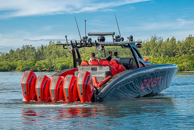 Slide: The Image of 2021 Midnight Express 43 Solstice boat with multiple red engines on a scenic waterway. - 49