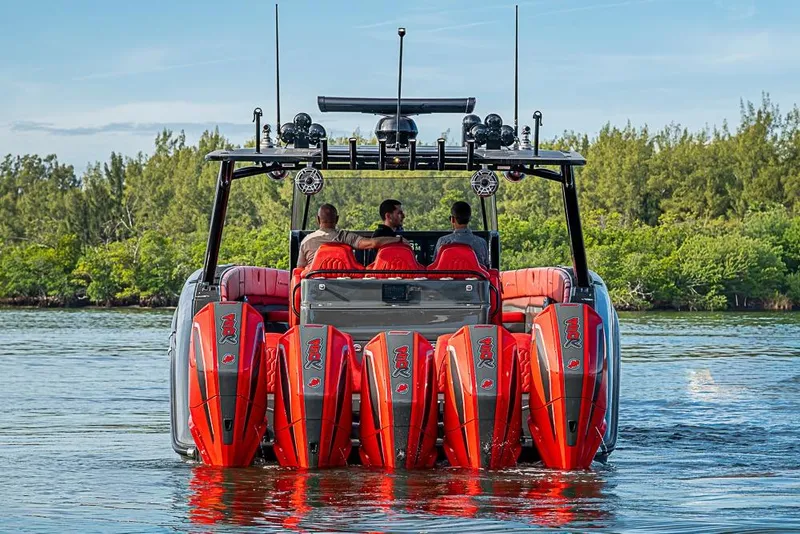 Slide: The Image of 2021 Midnight Express 43 Solstice boat with multiple engines on a serene waterway. - 5