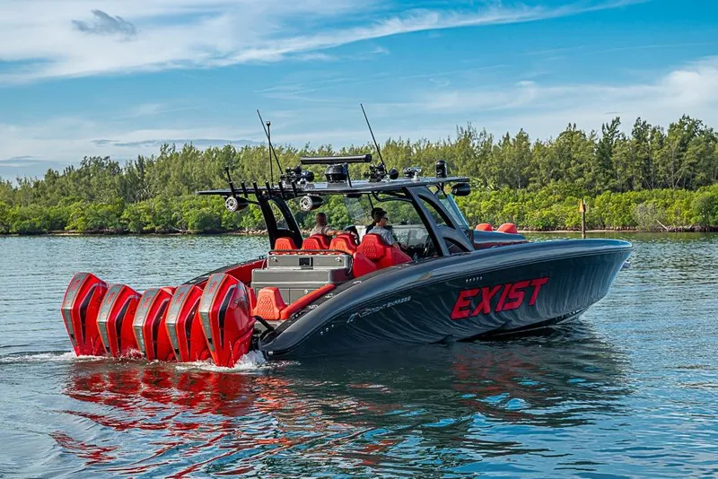 Slide: The Image of 2021 Midnight Express 43 Solstice boat with multiple engines cruising on a scenic waterway. - 50