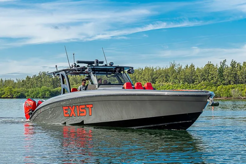 Slide: The Image of 2021 Midnight Express 43 Solstice boat cruising on a calm waterway with lush greenery. - 52