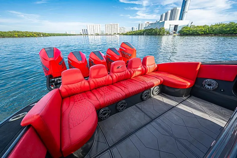 Slide: The Image of Red interior of 2021 Midnight Express 43 Solstice boat with multiple engines on a scenic waterway. - 7