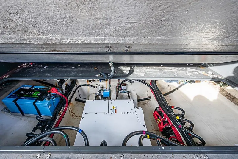 Slide: The Image of Engine compartment of 2021 Midnight Express 43 Solstice with visible wiring and battery. - 9
