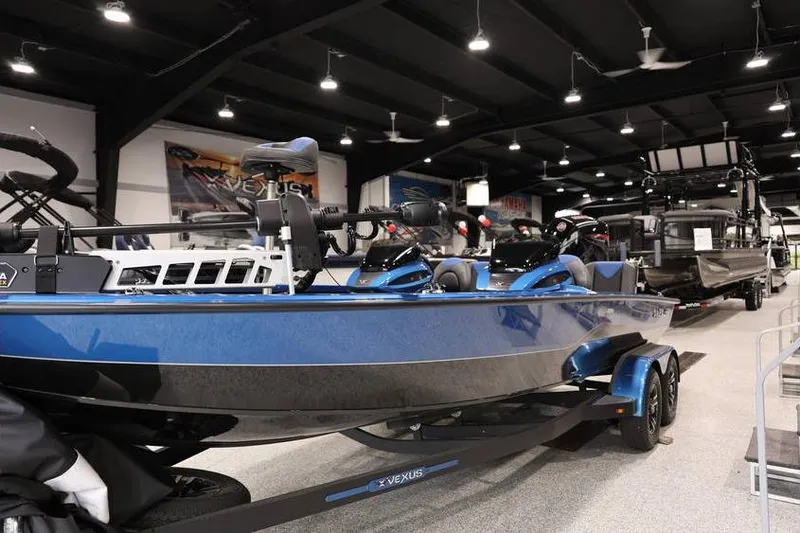 Slide: The Image of 2026 Vexus AVX 2085S boat displayed in a showroom, featuring sleek blue design. - 10