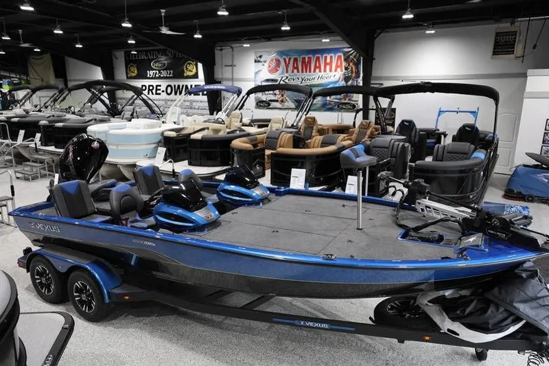 Slide: The Image of 2026 Vexus AVX 2085S boat displayed in a showroom with other boats. - 11