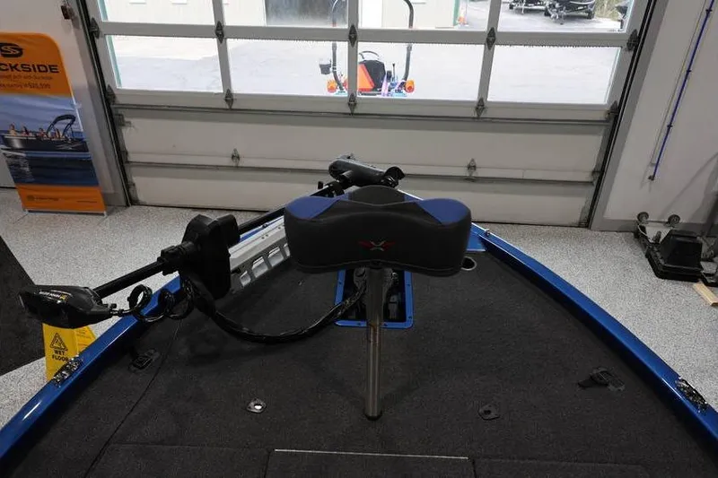 Slide: The Image of 2026 Vexus AVX 2085S boat interior with trolling motor in a garage setting. - 12