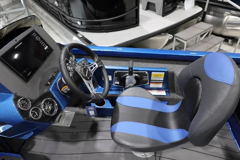 Slide: The Image of 2026 Vexus AVX 2085S boat interior with steering wheel and blue-accented seat. - 20