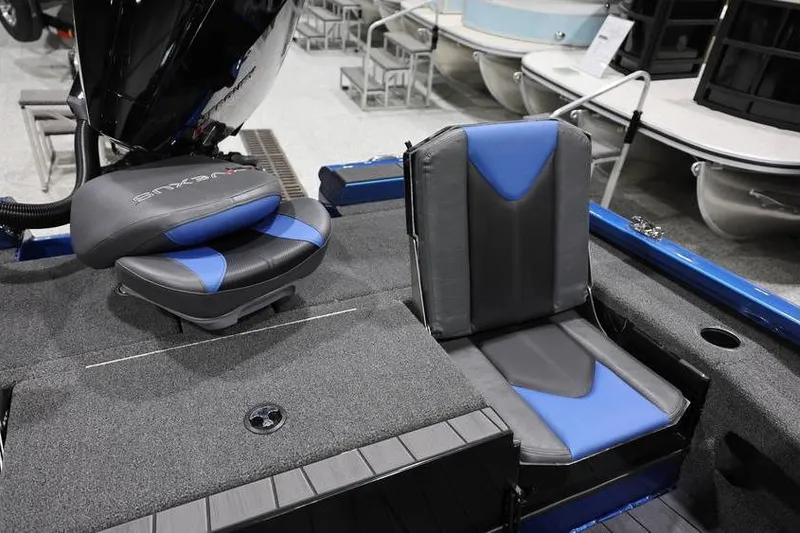 Slide: The Image of 2026 Vexus AVX 2085S boat seats, featuring blue and black upholstery in a showroom setting. - 28