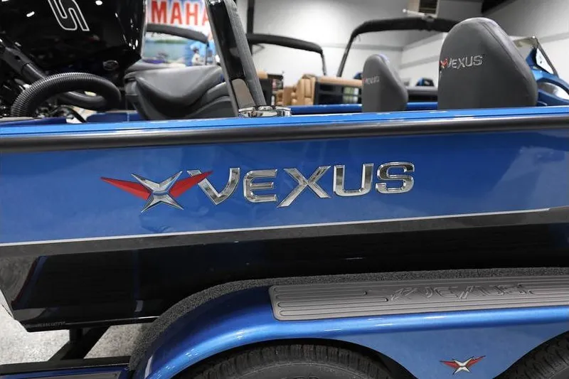 Slide: The Image of 2026 Vexus AVX 2085S boat, blue exterior with logo, displayed indoors. - 6
