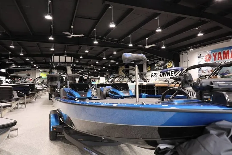Slide: The Image of 2026 Vexus AVX 2085S boat displayed in a showroom with other boats. - 8