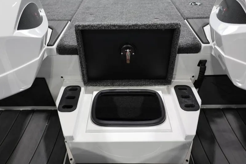 Slide: The Image of 2026 Vexus AVX 2100 boat interior storage compartment with carpeted lid and cup holders. - 17