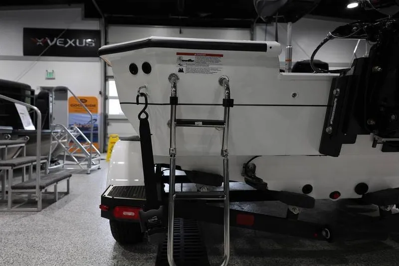 Slide: The Image of 2026 Vexus AVX 2100 boat rear view with ladder in showroom setting. - 20