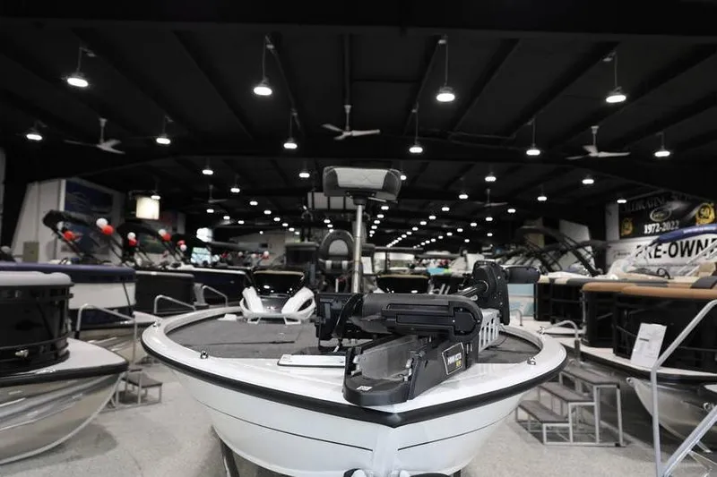 Slide: The Image of 2026 Vexus AVX 2100 boat displayed in a showroom with modern lighting. - 4