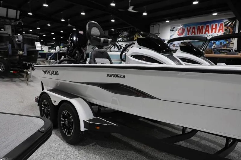 Slide: The Image of 2026 Vexus AVX 2100 boat on display in showroom with Yamaha signage. - 6