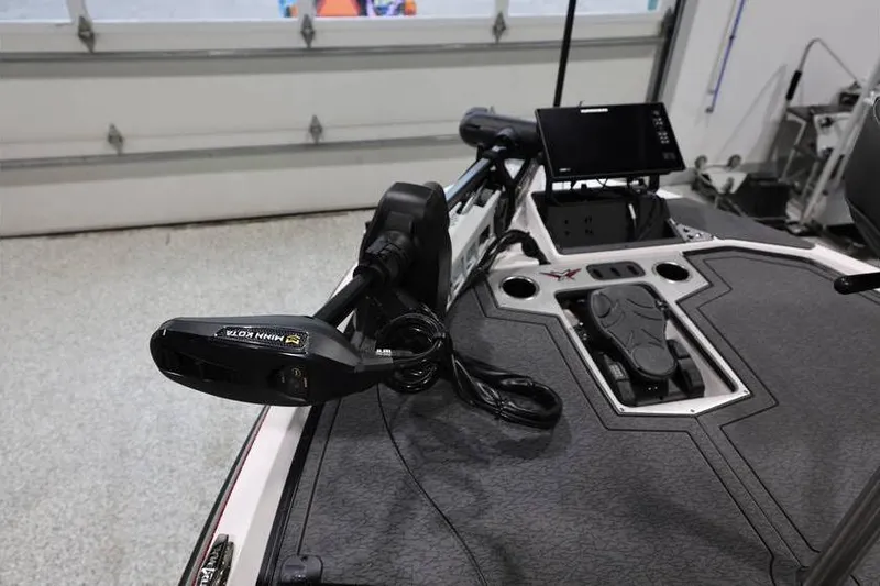 Slide: The Image of 2026 Vexus VXs21 boat with advanced trolling motor and navigation system in a garage. - 15