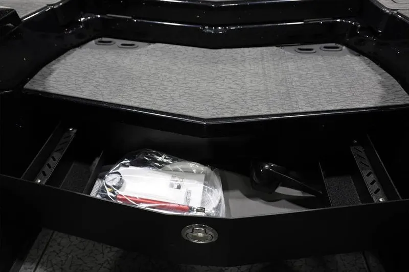 Slide: The Image of 2026 Vexus VXs21 boat storage compartment with accessories and textured surface. - 33