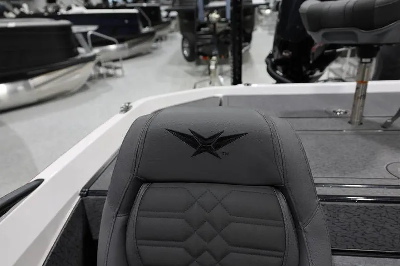 Slide: The Image of 2026 Vexus VXs21 boat interior with logo on gray seat in showroom. - 34