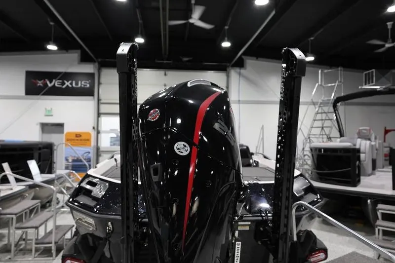 Slide: The Image of 2026 Vexus VXs21 boat engine in showroom, featuring sleek black and red design. - 5