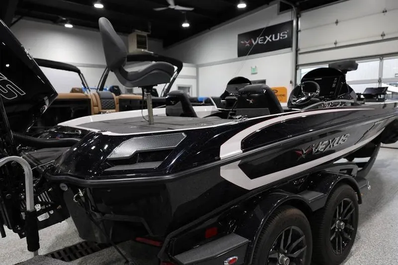 Slide: The Image of 2026 Vexus VXs21 boat in showroom, featuring sleek design and modern seating. - 7