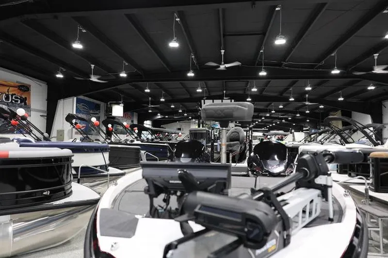 Slide: The Image of Indoor showroom displaying 2026 Vexus VXs21 boats with modern equipment and lighting. - 9