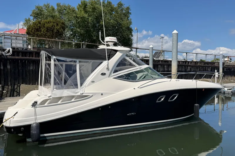 The Image of 2008 Sea Ray Sundancer 310 yacht docked in a marina under clear skies. - 0