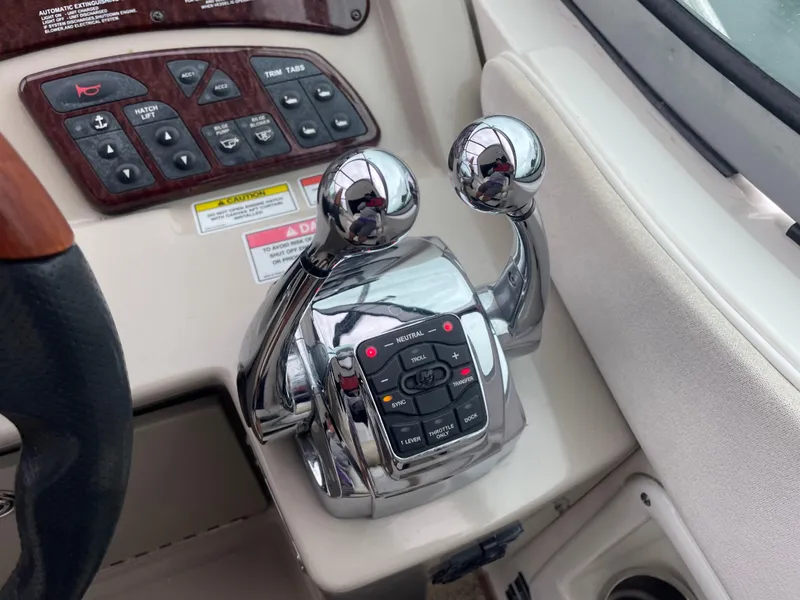 Slide: The Image of Close-up of the control panel and throttle of a 2008 Sea Ray 310 Sundancer boat. - 16