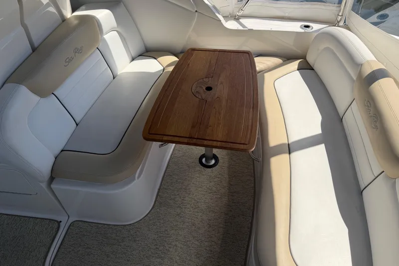 Slide: The Image of Interior seating area of 2008 Sea Ray Sundancer 310 with wooden table. - 18