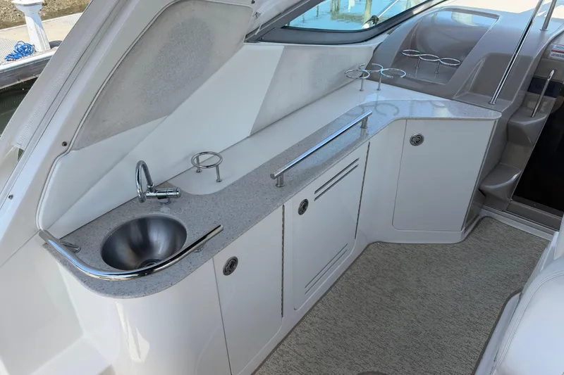 Slide: The Image of 2008 Sea Ray Sundancer 310 interior with sleek kitchenette and stainless steel sink. - 19