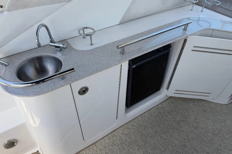 Slide: The Image of 2008 Sea Ray Sundancer 310 yacht kitchenette with sink, countertop, and mini fridge. - 20