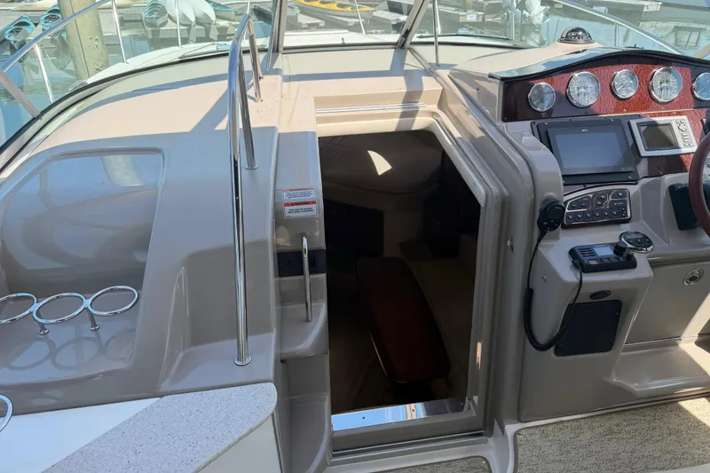 Slide: The Image of 2008 Sea Ray Sundancer 310 cockpit with helm, controls, and cabin entrance. - 22