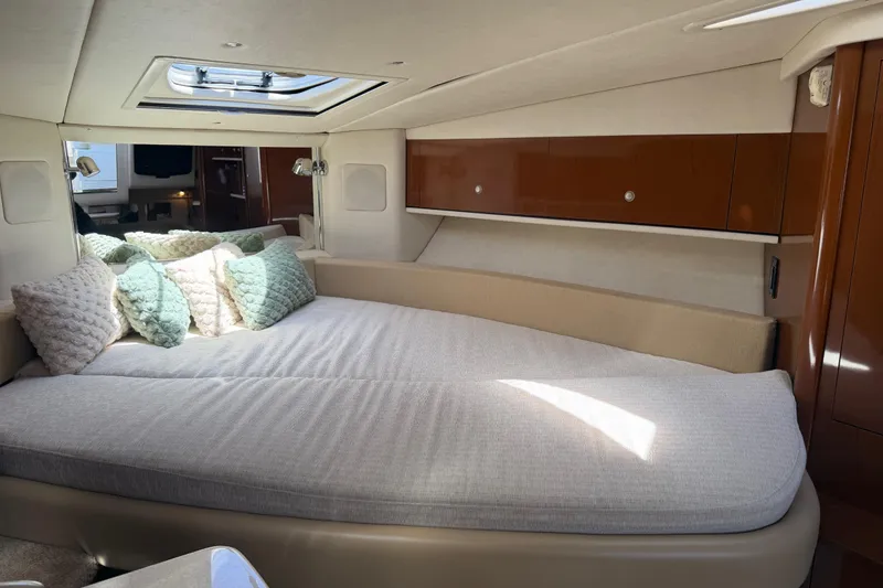 Slide: The Image of Luxurious cabin interior of 2008 Sea Ray Sundancer 310 with plush bedding and elegant wood finishes. - 25
