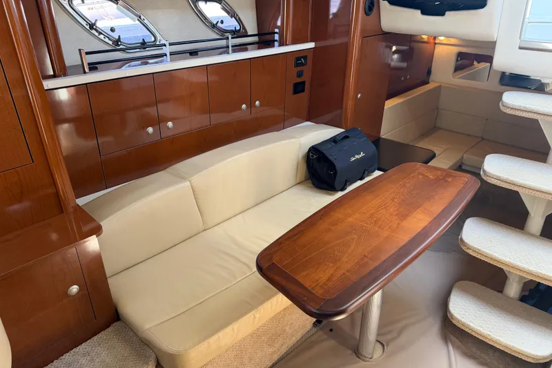 Slide: The Image of Luxurious interior of 2008 Sea Ray Sundancer 310 yacht with wooden table and beige seating. - 28