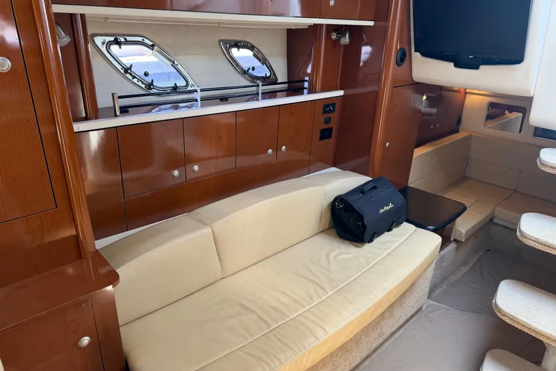 Slide: The Image of Interior of 2008 Sea Ray Sundancer 310 yacht with beige seating and wooden cabinetry. - 29