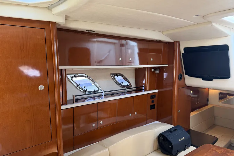Slide: The Image of Interior of 2008 Sea Ray Sundancer 310 yacht with wood cabinetry and mounted TV. - 30