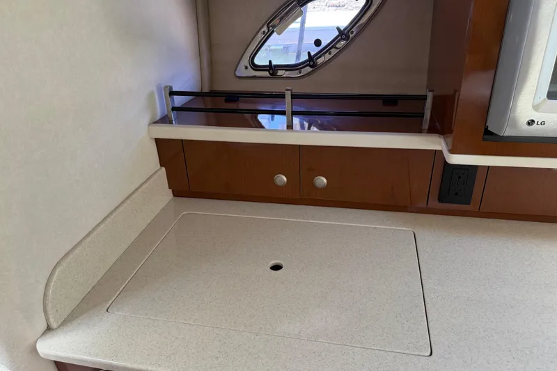 Slide: The Image of 2008 Sea Ray Sundancer 310 interior with countertop and porthole window. - 35