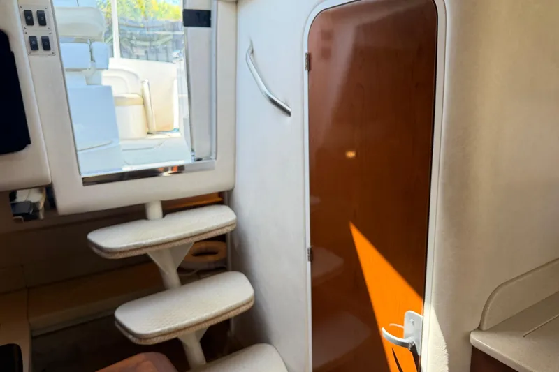 Slide: The Image of Interior of 2008 Sea Ray Sundancer 310 yacht with stairs and wooden door. - 38