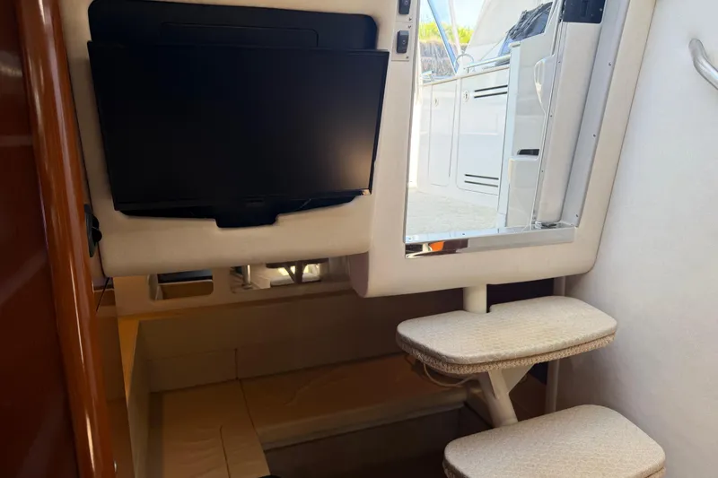 Slide: The Image of Interior of 2008 Sea Ray Sundancer 310 with TV, mirror, and cushioned steps. - 39